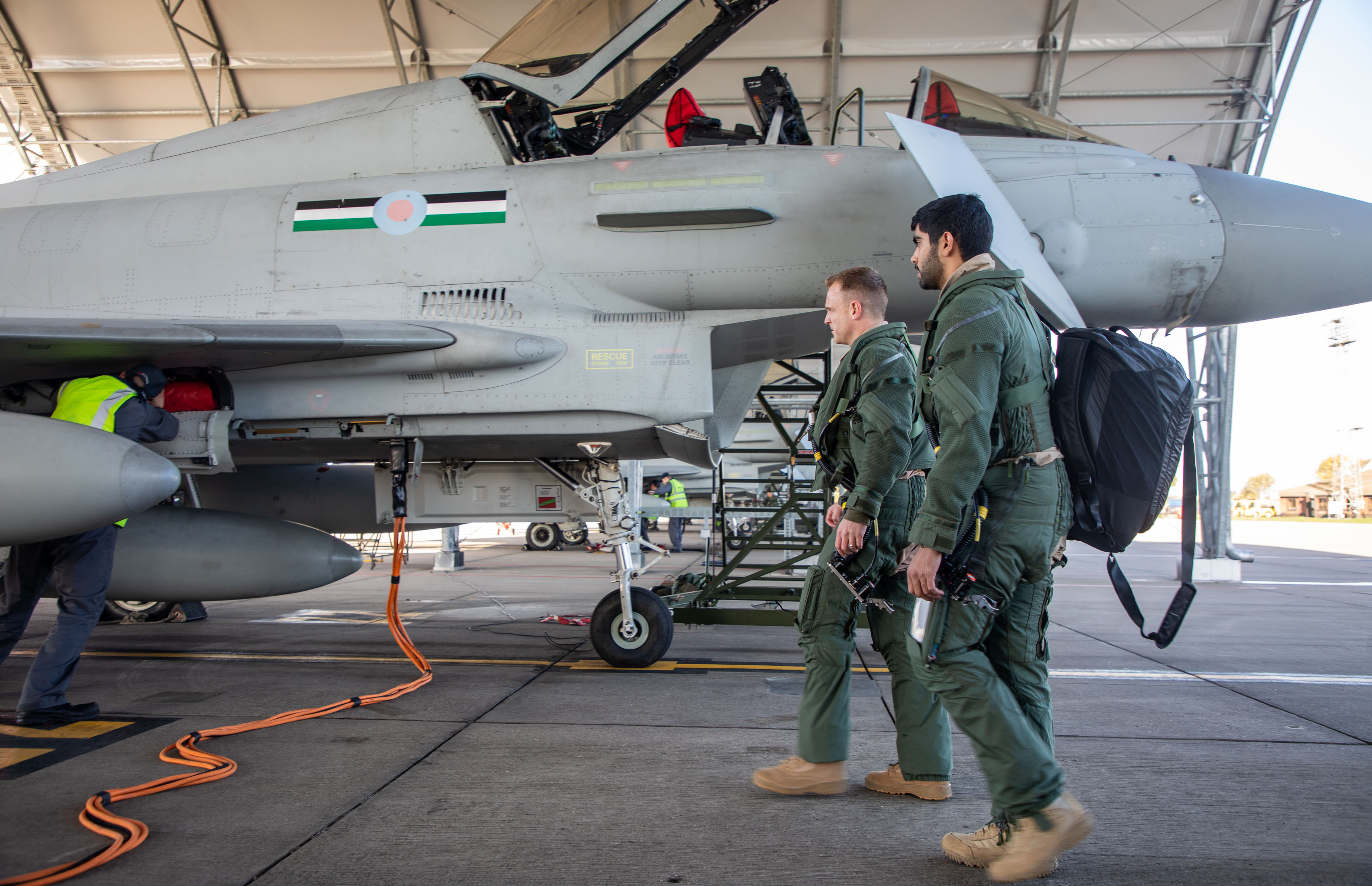 Image shows RAF aviators and Typhoon in the hangar